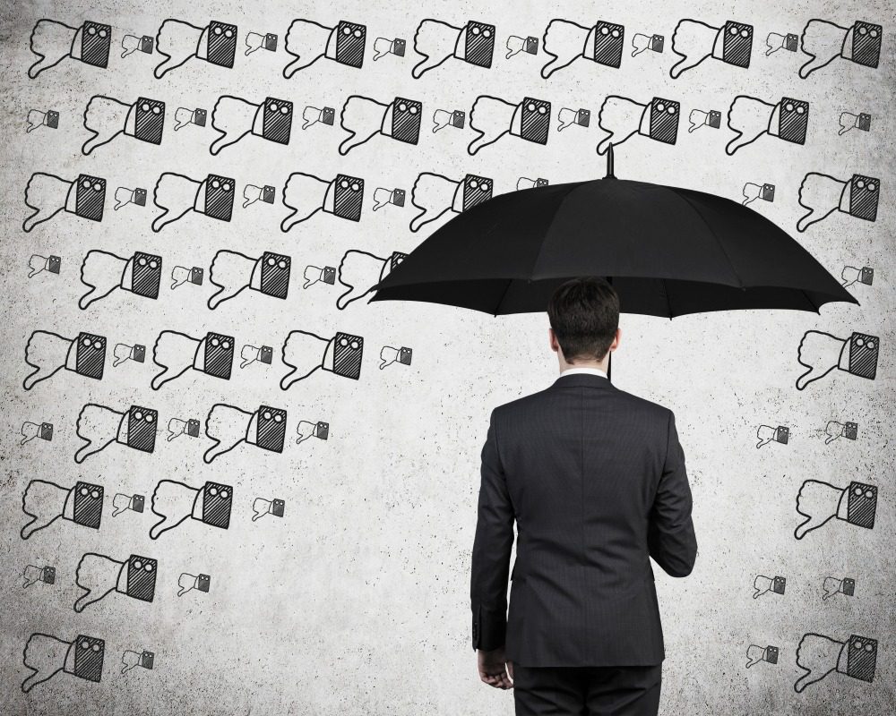businessman with umbrella and thumb down rain