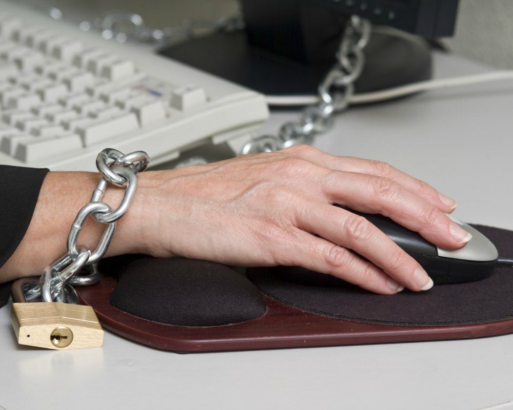 Employee padlocked to computer desk