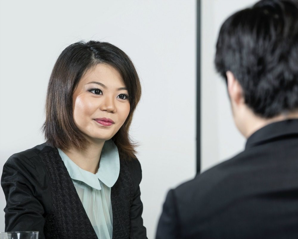 Chinese man having an interview with female manager.