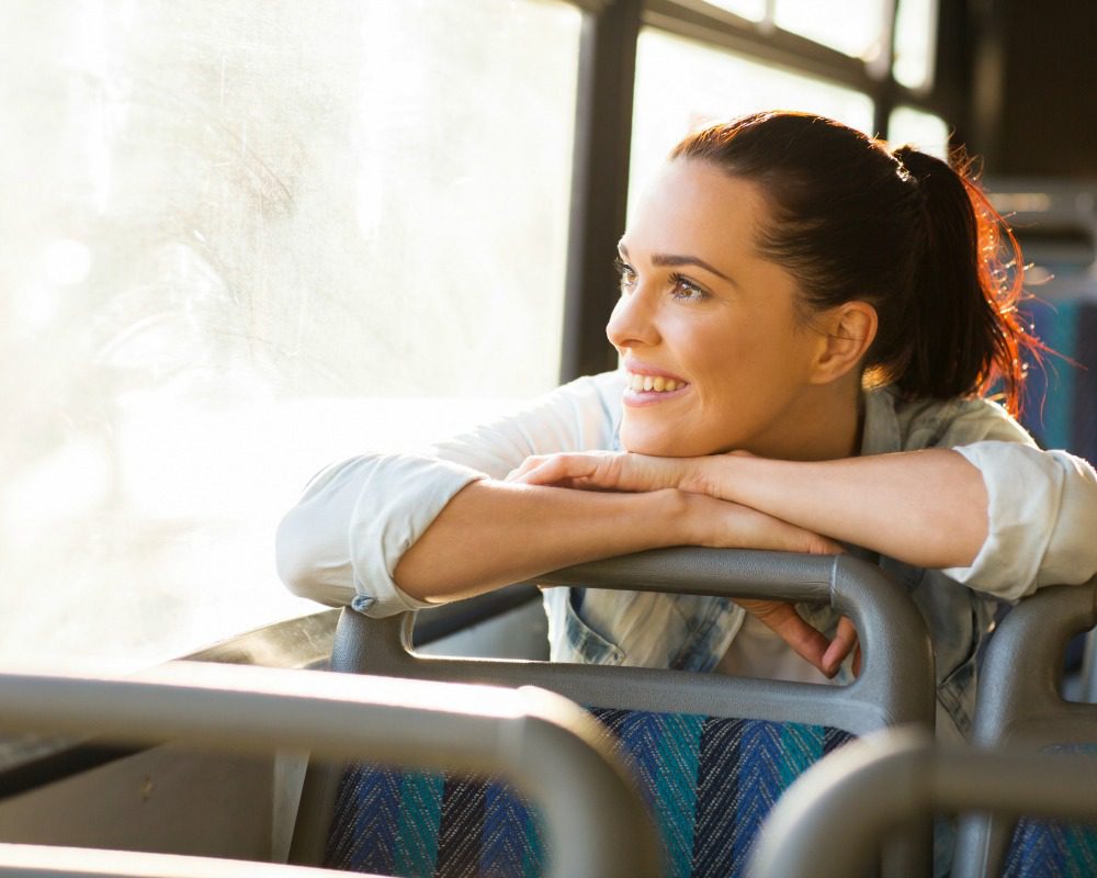 pretty female commuter daydreaming on bus