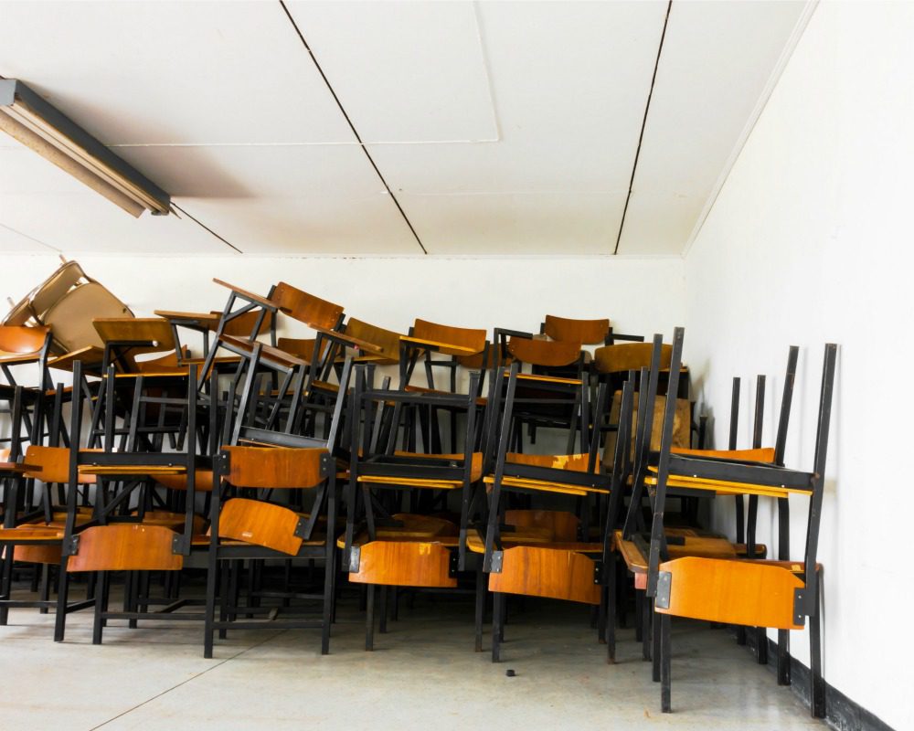 Old abandoned chair form classroom in the school.