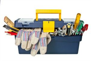 Plastic workbox with assorted tools on white background