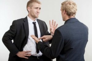 ywo you businessmen standing, discussing, arguing - isolated on light gray