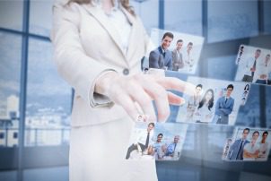 Businesswoman presenting partners pictures on digital interface