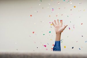 Businessman throwing confetti in the air