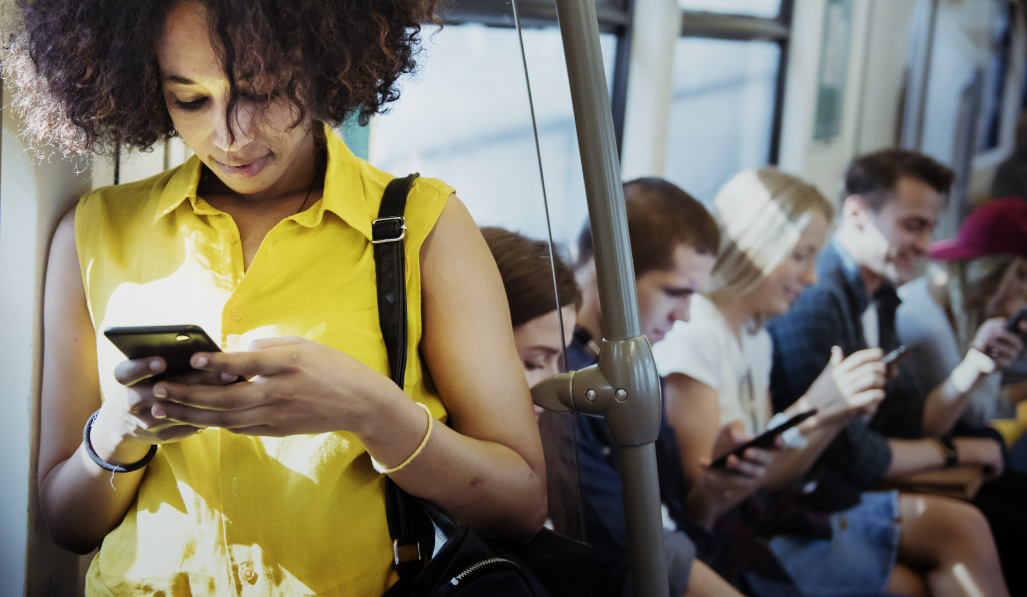 Young woman using a smartphone in a subway